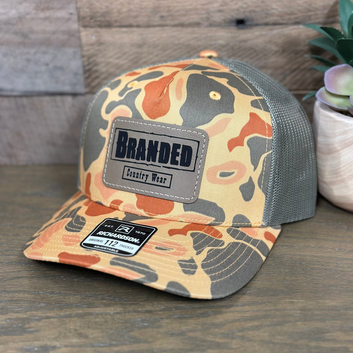 Branded Country Wear Leather Logo Patch Trucker Hat in Sienna Duck Camo