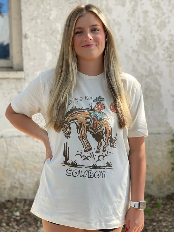 J Forks Designs It's Cool To Be Cowboy Graphic T-Shirt in Cream
